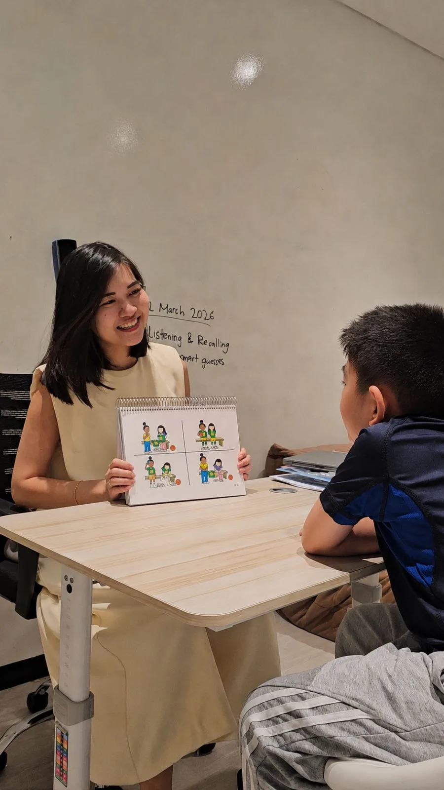 A therapist running an assessment activity with a boy