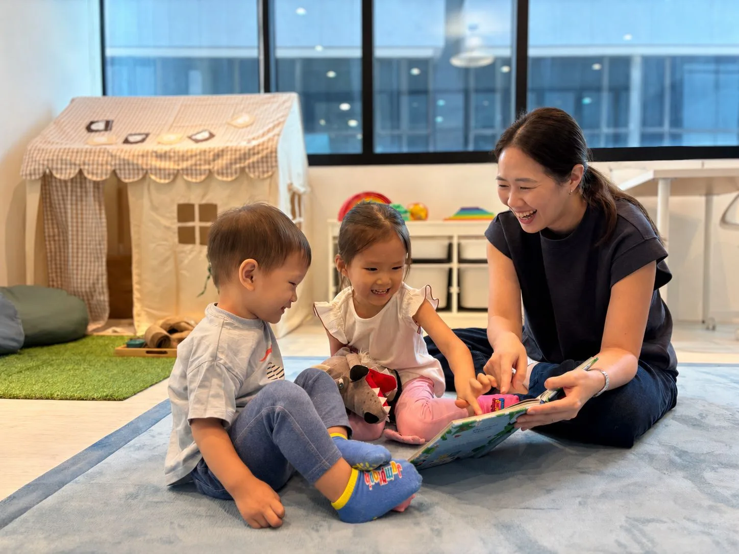 Our therapist reading with two children in the new space