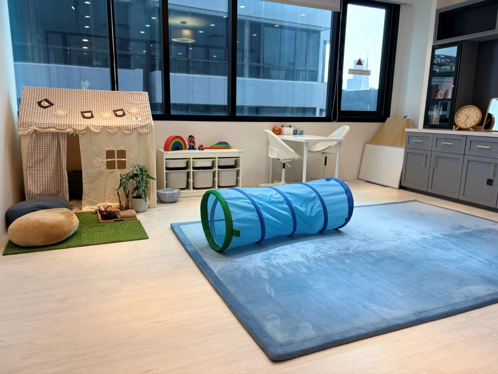 Our therapy room with the blue mat and play tent