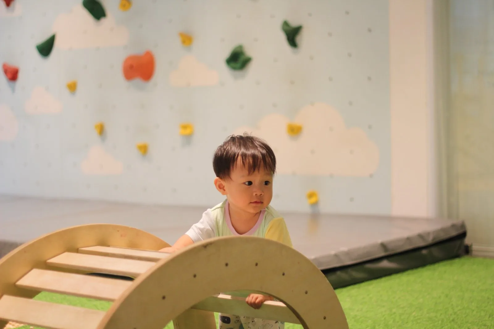 Toddler climbing at the indoor playground